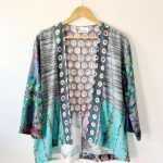 patchwork cardigan jacket in designer fabrics, bold and colourful, three quarter sleeves, hip length, front view